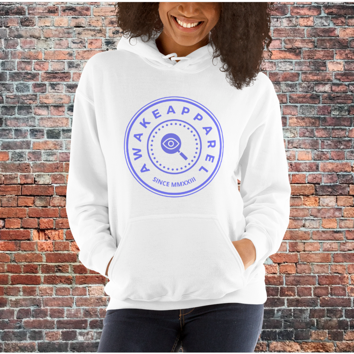 A young woman wearing a white Courageous Comfort Hoodie with the signature Purple Crest.